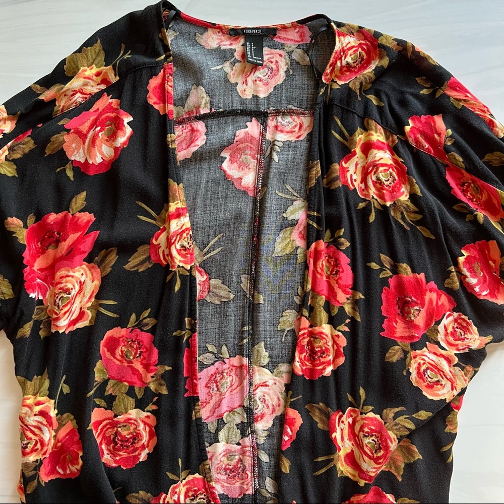 Lightweight, flowy, open top. Orange, red & black floral patterned blouse